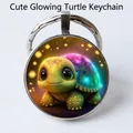 Silver round keychain featuring a 3D glowing cartoon turtle gem pendant design - Glowing Cartoon Turtle