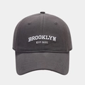 Detailed view of white Brooklyn Est 1631 embroidery on a charcoal grey cotton baseball cap - Adjustable / Gray
