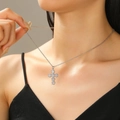 Silver cross necklace with micro-pave zircons worn by a model in soft lighting - 02 White k S08 Silver Full Diamond Cross Necklace