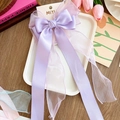 Large purple fabric bow hair clip with ribbons and satin organza finish on display card - Purple