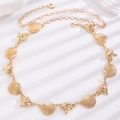 Detail of gold metal waist chain with polished seashell and conch links on white surface - KC Gold Conch Shell Style (F26)
