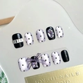 Detail showing handmade press-on nails with 3D purple bows and rhinestone dots - By1624 Bright Eyes And White Teeth / Glue Type