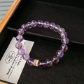 Close-up of purple amethyst beads and gold zircon spacer in a black jewelry box - Purple (Amethyst Beaded Bracelet)