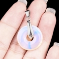 Handheld opal donut pendant with silver bail and blue glow on black background - 20mm Synthetic Opal