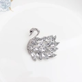Elegant swan brooch with silver base and sparkling crystal wings on white ceramic plate - Silver Swan (133)