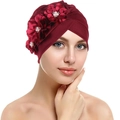 Detail of burgundy turban cap featuring three silk flowers with central pearl accents - Burgundy