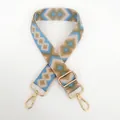 Detailed view of colorful geometric jacquard canvas strap with golden metal swivel hooks - Pattern No. 34