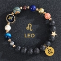 Macro shot of Leo zodiac beaded bracelet with blue sand stone and gold Leo charms - Leo