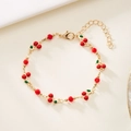 Detail of cherry bracelet with red faceted beads and adjustable gold lobster clasp - Cherry Pendant / Gold
