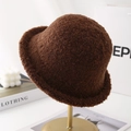 Detail view of a dark brown plush fisherman hat displayed on a premium gold stand - Brown