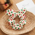 Detail of Christmas bow scrunchie with red and green polka dots on a wooden table - Rabbit Ears Style / Christmas Polka Dots