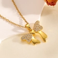 Macro shot of gold butterfly pendant with white pavé zircons on silk background - Gold Diamond Inlaid Polished Bowknot Necklace