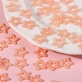 Close-up of pink star-shaped faux pearl charms for DIY crafts and phone case decoration - Orange