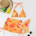 Detailed flat lay of a floral three-piece bikini set with a drawstring beach skirt - S / Yellow