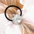 Close-up of a silver geometric metal charm on a black high-elasticity hair tie band - Silver