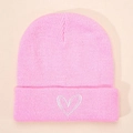 Close-up of fine knit pink beanie featuring a white embroidered heart on the cuff - Pink