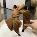 Hand holding elegant brown multi-layer bow headband with vintage pleated fabric texture - Multi-layer Side Bow / Brown