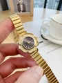Detailed close-up of a gold flower-shaped vintage watch with a black dial on wrist - Gold Band / Black Dial