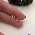 Vintage golden hollow heart stud earrings with a small white crystal inlay detail - Intertwined Rhinestone Stud
