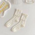 Detail of white ruffle edge socks with delicate pink floral embroidery and vertical texture - Cream Pink Embroidery Ruffle