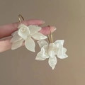 Detail of cream white camellia flower earrings with elegant golden hook and pearl finish - 12# Camellia Shape Creamy White Earrings (HE15735)