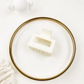 Detail view of cream white matte square claw clip on elegant ceramic dish - Milk White