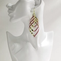 Fashionable gold-plated spiral leaf earrings with pink glitter finish on model - NRXY-1378-2 Gold Pink Glitter