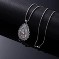 Vintage silver teardrop necklace with turquoise gemstone and rhinestones on black stand - Colorful Rhinestone Drop
