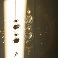 Hanging suncatcher with heart and star crystals creating rainbow light reflections - Design No.7