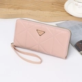 Pink PU leather long wallet with wristlet and triangle emblem on elegant still life setting - Pink