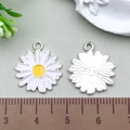 Macro detail of daisy charm pendant next to a wooden ruler showing a 2cm diameter size - White Chrysanthemum 16x18mm