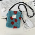 Close-up of blue fleece crossbody bag with red hearts and woven strap on a desk - Blue Background Red Hearts