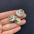 Three natural shell pendants with gold edges for jewelry making held in hand - No.9 (Natural Shell - Gold Edge)