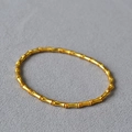 Matte vergoldete Bambus-Gliederarmband im neuen chinesischen Stil für Damen auf grauem Grund - Mattierte antike Goldbeschichtung Dünner Stil