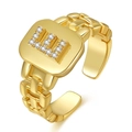 Adjustable gold watch-strap style open ring featuring a sparkling rhinestone letter E - Letter E