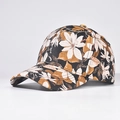 Close-up of floral print patterns on the black canvas fabric of this baseball cap - Style 03 / Black with White and Caramel Flowers
