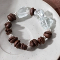 Close-up of coffee bean bracelet with silver hollow beads and blue crystal on ceramic tray - Coffee Bean + Light Blue Stone + Silver Spacers