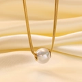 Detail of 18K gold snake chain with a radiant white pearl pendant on silk fabric - Large Artificial Pearl Style (H47) / Necklace / Gold