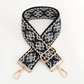 Close-up of ethnic jacquard strap with diamond pattern and gold metal swivel hooks - Beige Dark Blue Floral