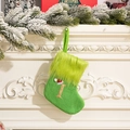 Green knit Christmas stocking with glitter letter I on faux fur cuff hanging on fireplace - Letter I