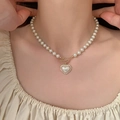 Detail of heart pearl necklace with golden OT buckle and shell pendant on model - White Heart Shell Necklace (HN4865)