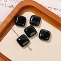Macro detail of square black natural stone beads with white veins on a beige pad - Black White Striped Polished Square Style (20号)