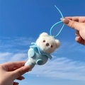 Cute white plush bear keychain with blue suede outfit shown against a clear blue sky - Gourd Bear - Blue