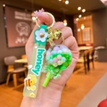Lollipop shaker keychain with pastel beads, green honey strap and golden bell charm - Green Luminous Color Bean Lollipop