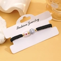 Adjustable black woven bracelet with white volleyball bead and small red heart detail - 05 KC Gold Volleyball Style