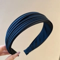 Detailed view of layered navy blue satin fabric folds and anti-slip lining on headband - Ruched Layered Style / Black