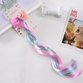 Close-up of a colorful unicorn hair clip with pink bow and gradient braided wig extensions - Pink Purple Green