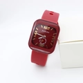 Detailed close-up of square red watch with textured dial and silicone strap on display - Red Numbers