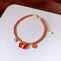Detail of red braided bracelet with 18k gold-plated fortune bag and zircon charms - 18K Gold Plated Red String Fortune Bag Bracelet (WB1996)