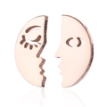 Macro shot of rose gold abstract face earrings featuring creative split circle design - Rose Gold